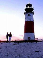 Theresa Olson, left, of Leadville, Colo., walks with Carolyn Sperry
past the Sankaty Light House on Nantucket, Mass. The
3-mile-by-14-mile island, some 30 miles out into the Atlantic Ocean
off Cape Cod, Mass., has an intrinsic beauty all its own an
unmistakable passion for its whaling heritage coupled with New
England charm.