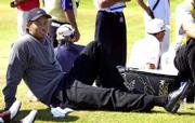 Tiger Woods relaxes while waiting to tee off on the fifth hole
Friday in the British Open. Woods takes a three-shot lead into the
third round.