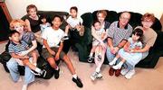 Larry and Brenda Compton, at right, have adopted six foreign
children with a seventh on the way to add to their three daughters
by birth. From left are Dimitri, 5; Courtney, 22; Bethany, 19;
Taryn, 2; Evan, 11; Kenyan, 3; Rider, 2; Adrian, 24; Larry; Tia, 3;
and Brenda.