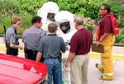 A hazardous waste scare at the Sallie Mae loan servicing center has
Lawrence-Douglas County Fire & Medical personnel donning
protective clothing. The Fire & Medical employees were
receiving instructions from Lawrence police before entering the
loan servicing center, where an envelope was thought to contain a
toxic substance.
