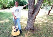 Lawrence musician Lance Fahy has released a CD titled "Songs for
Sale." Fahy, shown in his back yard, describes his music style as
an acoustic mix of rock, folk and country.