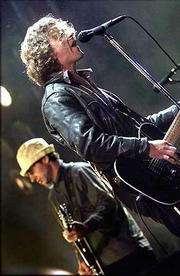 Pearl Jam's Eddie Vedder plays at an outdoor rock music festival in
Roskilde, 18 miles west of Copenhagen, Denmark. Eight fans were
trampled to death during the concert June 30. The band paid tribute
to Elvis Presley during a concert at The Pyramid in Memphis, Tenn.