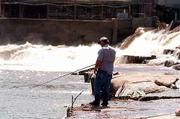 Ed Carson of Olathe fishes off the Bowersock Dam on the Kansas
River. New rules are being considered and probably will pass
allowing wastewater treatment plants and private companies like
Farmland Industries Inc. to discharge more ammonia into the state's
rivers, environmentalists say.