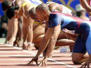 Maurice Greene of the United States prepares for the start of his
100-meter heat. Greene won his heat Friday in Sydney, Australia.