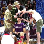 Jeff Carey gets his locks chopped by teammates, from left, Kenny Gregory, Eric Chenowith and Luke Axtell in this October 2000 file photo. The haircut took place Friday night at Allen Fieldhouse during Late Night With Roy Williams festivities.