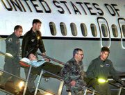 An unidentified U.S. sailor is carried on a stretcher down the
gangway of a cargo plane at Rhein-Main Air Base near Frankfurt,
Germany. The soldier is part of a group of wounded who arrived
Saturday from Aden, Yemen. The injured were being taken by bus to
Landstuhl, about 60 miles southwest, for evaluation and treatment.
Seventeen sailors died and 33 were injured in the explosion on the
USS Cole while it was refueling Thursday in the Yemeni port of
Aden.