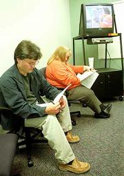 Mike Schneider, left, and Penny Lentfer, both of Topeka, fill out
applications for customer service jobs at Sprint PCS's Lawrence
Customer Care Center in the Lawrence Riverfront Plaza. The
nationwide unemployment rate is at its lowest level in 30 years.