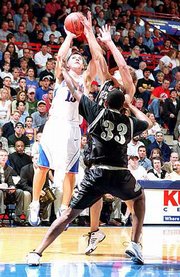 Kansas' Jeff Boschee, left, shoots over Emporia State's LaChance
Murray (33). Boschee scored 17 points in KU's 120-51 exhibition
victory Saturday night at Allen Fieldhouse.