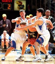 The Jayhawks' Jeff Boschee, left, and Kirk Hinrich apply pressure
against Emporia State's Ryan Adkison. Kansas rolled to a 120-51
exhibition victory over Emporia State on Saturday night at Allen
Fieldhouse.