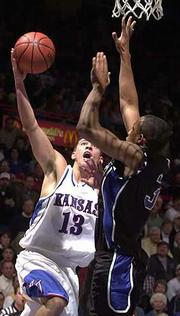 Kansas' Jeff Boschee (13) scores against Middle Tennessee State's
Kevin White. Boschee had 19 points and six assists Monday at Allen
Fieldhouse.