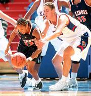 Kansas University's Kristin Geoffroy, right, grabs the arm of
Illinois' Shavonna Hunter during the Jayhawks' 73-60 victory on
Tuesday. Geoffroy was called for a foul on the play.