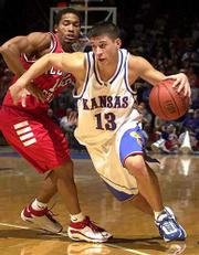 Kansas' Jeff Boschee (13) drives past ISU's Randy Rice. Boschee
finished with seven points Thursday.