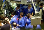 Traders on the floor of the New York Stock Exchange execute orders
as Wall Street struggles through weak earnings reports. The Dow
closed down 2 percent, or 214.62, at 10,414.49 on Thursday. It fell
more than 335 points in afternoon trading.