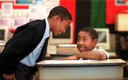 Michael Davis Jr., left, and Tyler Butler hang out in their
fourth-grade classroom as they wait for Butler's mother. Davis and
Butler are two voucher students at St. Adalbert School in
Cleveland. A federal appeals court Monday declared Cleveland's
school-voucher program unconstitutional because it uses tax money
to send students to religious schools.