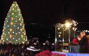Protected behind bulletproof glass during the Pageant of Peace
ceremony on the Ellipse, President Clinton looks out over the crowd
after he turned on the lights of the National Christmas Tree. The
tree-lighting ceremony was Monday.