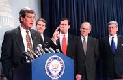 Senate Majority Leader Trent Lott of Mississippi, left, accompanied
by fellow Republican senators, meets reporters on Capitol Hill
after the GOP and Democrats agreed on how to run a Senate divided
50-50. Shown Friday from second left are Sen. Bill Frist, R-Tenn.,
Sen. Rick Santorum, R-Pa., Sen. Larry Craig, R-Idaho and Sen. John
Warner, R-Va.