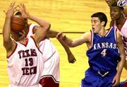 Texas Tech's Cliff Owens (13) takes a rebound to the face as KU's
Nick Collison (4) looks on. Owens had 10 rebounds and Collison had
12 points and six boards Saturday in Lubbock, Texas.