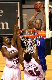 The Jayhawks' Drew Gooden (0) launches a shot over Tech's Jayson
Mitchell, left, and Johnny Phillips.