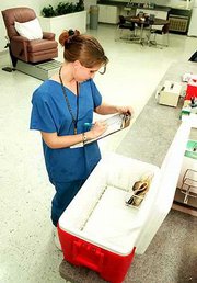 Few donors gave blood Tuesday at the Community Blood Center, 535
Gateway Drive. Here, Sarah Mozykowski checks the only donation as
of mid-afternoon.