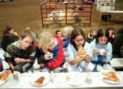 A group of Deerfield Elementary School fourth-graders enjoys a
pizza made from ingredients from beef and dairy cows, vegetables
and grains. Hundreds of Lawrence schoolchildren experienced some
lessons on the meaning of agriculture in their lives during the
"Slice of Agriculture" program Monday at the Douglas County 4-H
fairgrounds. From left are Taylor Stuart, Taeler King, Jessica
Aranda and Apollonia Shreders.