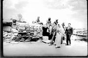 A newly married Vietmanese couple and their best man walk past a
sandbag bunker manned by American G.I's on the edge of Saigon in
1968. They were heading for their wedding reception and due to
security cars were not allowed to drive into the area.