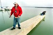 Clinton Lake Marina security guard Ed Moore checks to see whether
fish are biting Friday as marina store workers install carpet on
the fuel docks. A Lawrence biologist predicts that Lawrence could
be left high and dry within 20 years as the city's growth outstrips
its water supply.