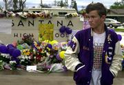 A makeshift memorial for victims of the Santana High School
shooting is growing. Tuesday, student Erik Wallingford visited the
memorial in Santee, Calif. Wallingford is a friend of slain student
Randy Gordon.