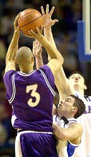 Kansas State's Quentin Buchanan (3) launches a shot over KU's Brett
Ballard, center, and Nick Collison.