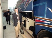 Kansas University Men&squot;s basketball player Brett Ballard boards a
bus bound for Topeka&squot;s Forbes Field as the team begins its trek to
the NCAA Midwest Regional in Dayton, Ohio. After a dinner Wednesday
at Allen Fieldhouse, the team left with little fanfare. Also
pictured are, from back, Todd Kappelmann and Drew Gooden. See
<a href="http://www.ljworld.com/section/tourney" target=
"new">kusports.com.</a>