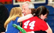 Kansas men's basketball coach Roy Williams embraces two young fans
from Ottawa, Sarah Walters, right, and Crystal Thrall. About 1,000
fans turned out Saturday night to greet the team on its return to
Allen Fieldhouse.