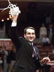 Duke coach Mike Krzyzewski holds up the net that was cut after Duke
won the NCAA East Regional title. The Blue Devils downed USC,
79-69, on Saturday in Philadelphia.