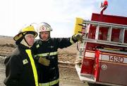 Kanwaka Fire Department volunteers Bob Rombach, left, and Fire
Chief Chris Lesser survey the scene during a recent call for a
standby unit at a medical helicopter landing in western Douglas
County. Township fire departments rely almost completely on
volunteers to provide protection in the county.