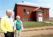 The big Springs Community Assn. wants to restore an old brick
schoolhouse, with help from Lecompton Township. Chuck Wright, left,
and Iona Spencer, photographed Friday, would like to see the
building used for community gatherings.