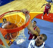 Duke's Carlos Boozer slams home two points against Maryland. The
Blue Devils rallied from a 22-point first-half deficit for a 95-84
win in a national semifinal game Saturday night in Minneapolis.