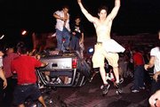 University of Arizona fans overturn cars before setting them on
fire in Tucson, Ariz., after the Wildcats lost to Duke on Monday
night in the NCAA championship game. A motor home and several cars
were set on fire and several businesses were vandalized.