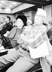 Richard Postma, right, 1012 N. 600 Road in Baldwin, listens to
bankruptcy attorneys talk about the status of the Farmers
Cooperative Assn. at a January meeting.
