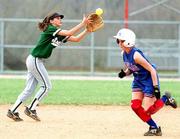 Free State's Amy Vormehr, left, hops for a pop fly as Olathe
North's Tara Smethers heads for second base. The Firebirds lost
both ends of a doubleheader on Thursday at FSHS.