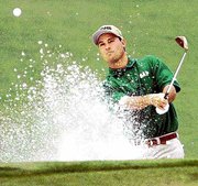 Chris DiMarco hits from a bunker on the 17th hole during the first
round of the Masters. DiMarco shot an opening-round 65 Thursday at
Augusta National Golf Club for a one-stroke lead.