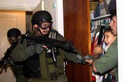 Alan Diaz of the Associated Press won the Pulitzer Prize for
breaking news photography for this photo of the rescue of Elian
Gonzalez. In the photo, Donato Dalrymple, far right, holds
6-year-old Elian during the predawn hours of April 22, 2000, as
government agents stormed the Miami home to seize custody of the
boy.