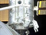 Canadian astronaut Chris Hadfield, upside down, and astronaut U.S.
Scott Parazynski install the UHF antenna on the outside of the
international space station during spacewalk Sunday. The antenna
will provide ship-to-ship communications during docking and
undocking operations.