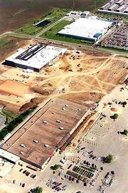 South Iowa Street is the city's largest commercial district, more
than a decade after city officials rejected plans for a "cornfield
mall" in the area. They relied on language in Plan '95 to make
their case. In this aerial taken three years ago, crews were
building a new Kohl's department store (center) between Kmart
(foreground) and Wal-Mart (top).