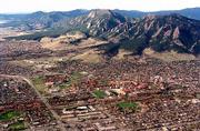 The needlesharp Flatirons form a mountain backdrop for Boulder,
Colo., a cosmopolitan city with a population of more than 95,000
people. City and county efforts to purchase and preserve open space
have enabled Boulder to save wildlife habitat, agricultural lands
and their mountains from development. This view shows the Flatirons
to the southwest at top of frame with protected green space below.
Just below center at right is the University of Colorado.