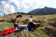 Green space is readily accessible in Boulder, where the city and
county have worked together to purchase and preserve open space
around the community. University of Colorado students Amalie
Veralli, left, and Margot Hackman paint and study in Chautauqua
Park on a spring day in 2001.
