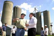 Sergio Martinez, a representative of the Cuban Interest Section in
Washington, D.C., left, talks with Douglas County farmer Mark
Wulfkuhle about his family's cattle business. Martinez toured the
Wulfkuhle's Rocking H Ranch Saturday.