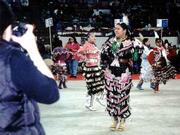 Jessica Youngbird, a Haskell Indian Nations University student,
participated in the jingle dress competition at the Denver March
Powwow. Her dress is decorated with appliques and jingles made from
the lids of tobacco cans.