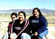 Haskell Indian Nations University students, from left, Tracy
Kennedy, Jessica Youngbird and Ashley Youngbird rest after taking a
hike on a mesa near Acoma Pueblo. In the background is Mount
Taylor.