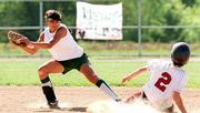 Free State's Amy Vormehr, left, catches a throw to force Lawrence
High's Jennifer Narcomey. The Firebirds recorded the out, but the
Lions rolled, 10-0 and 12-2, over FSHS on Tuesday at Free State.