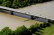 Vehicles roll across the Kansas Turnpike Authority bridges above
the Kansas River Wednesday near the East Lawrence Interchange. The
KTA will replace the two bridges at an estimated cost of $77
million.