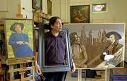 Lawrence artist Wayne Wildcat has been desginated a millennium
artist and will spend six weeks in Guam exhibiting his works and
teaching. Wildcat poses Thursday with some of his recent paintings.