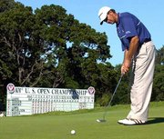 Retief Goosen watches his birdie putt roll into the cup on the
ninth green. Goosen shot a 1-under-par 69 Saturday at Southern
Hills Country Club in Tulsa, Okla., to tie for the lead.